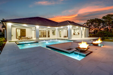pool of custom built home at sunset by bellamia development